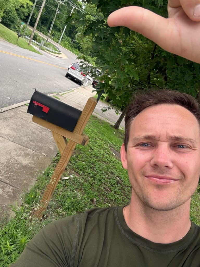 Mailbox Bros team member at a finished black post-mount mailbox install in Houston